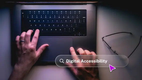 A person's hands are typing on a laptop keyboard, with a search bar displaying 'Digital Accessibility' and glasses nearby.