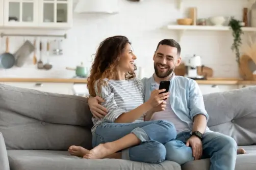 Happy couple using a smartphone