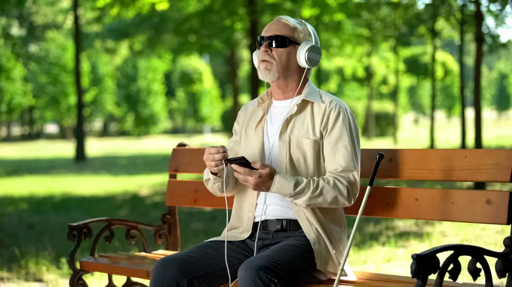 Blind man sitting in a park
